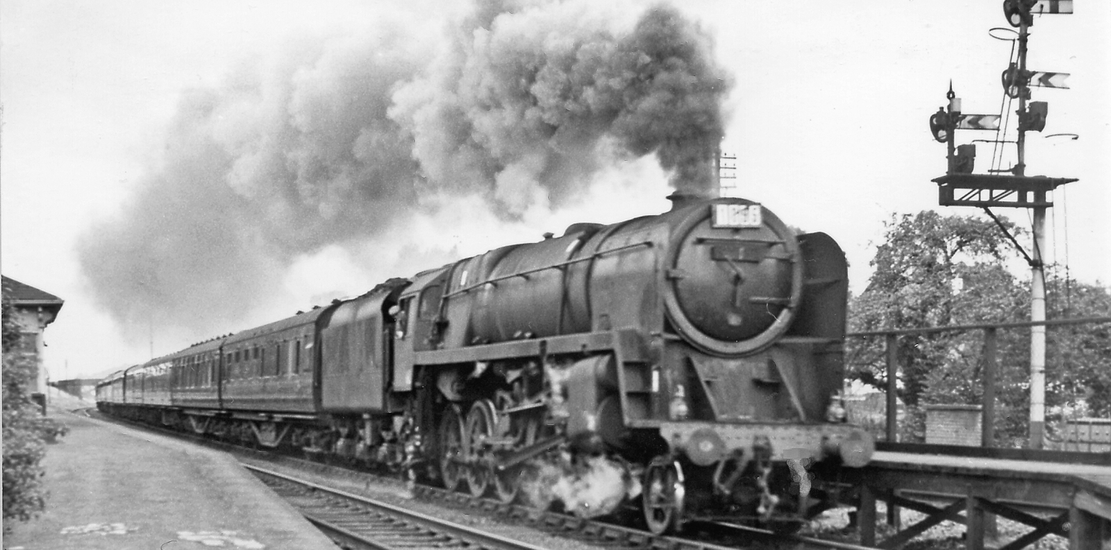The 90 mph fast BR Standard class 9F in front of an express train.
