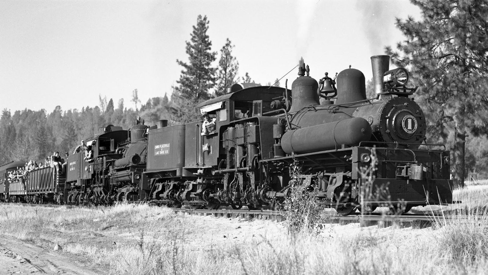 Camino, Placerville & Lake Tahoe No. 1 and 2 in 1951 in front of an excursion train at Smith Flats