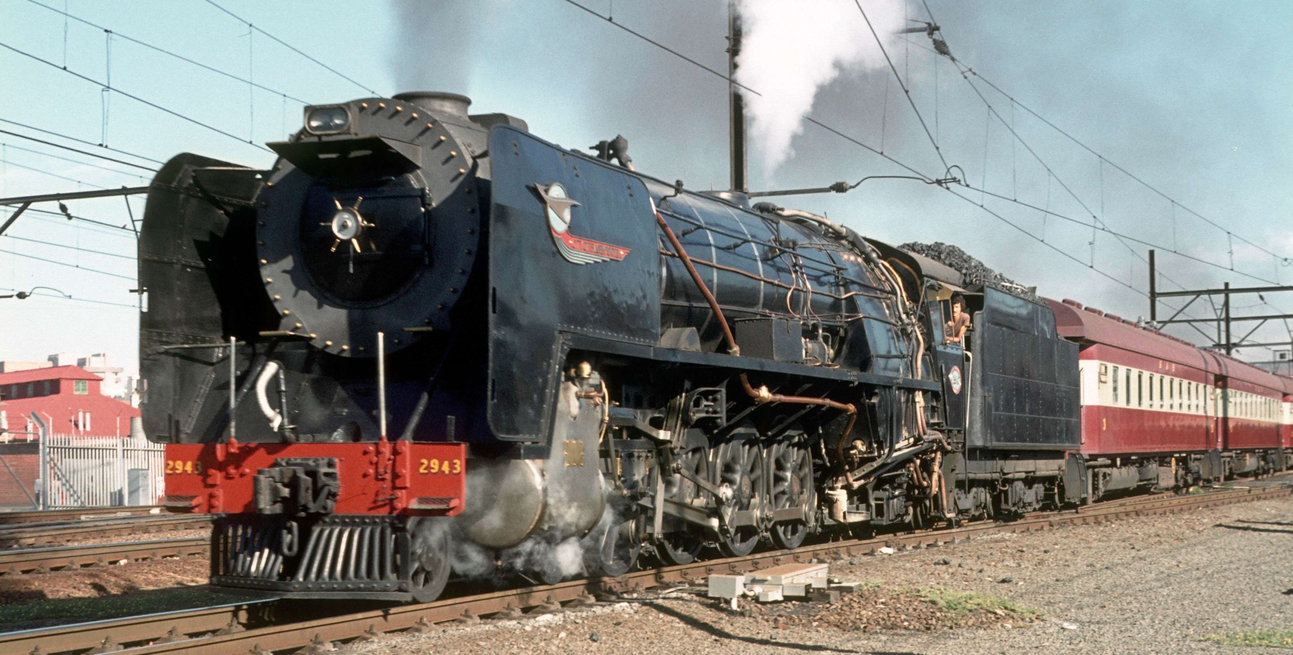 No. 2943 leaves Bloemfontein Station with a passenger train in 1981